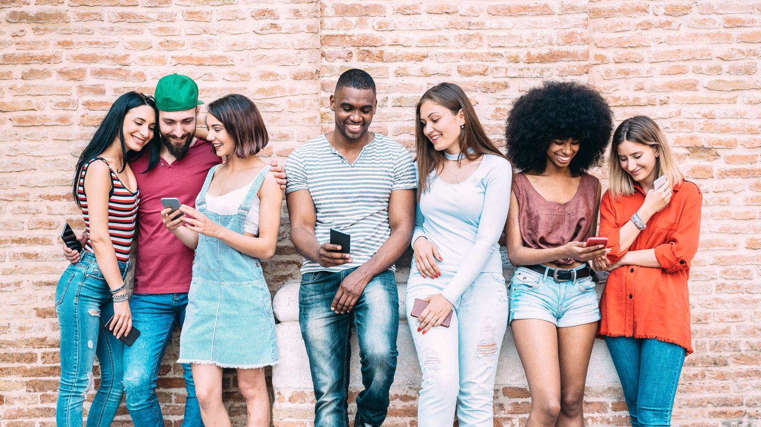Multiethnic friends using smartphones for marketing and business advice.