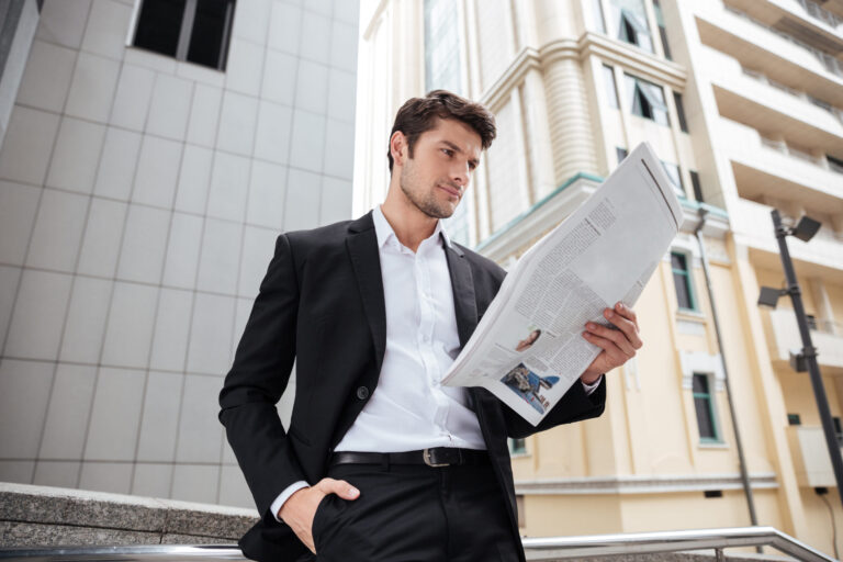 businessman reading newspaper in the city 2021 08 26 18 20 01 utc scaled